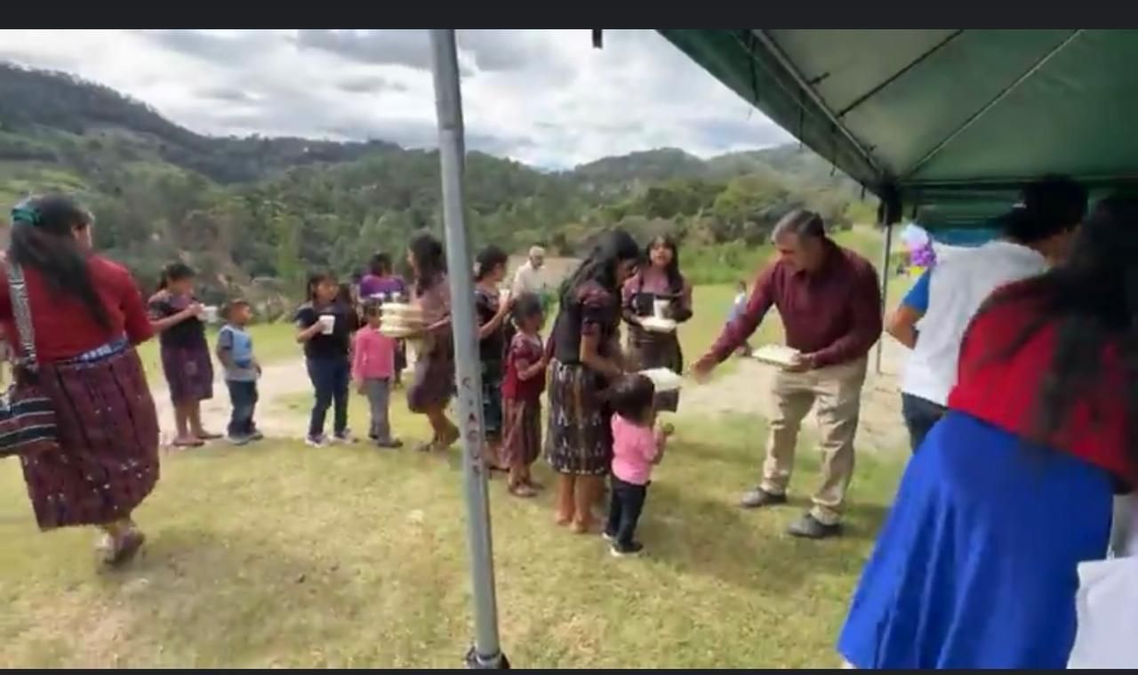 Community members gathered by the tent